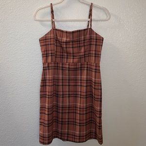 Burnt orange/copper colored dress with plaid type details. Adjustable straps.